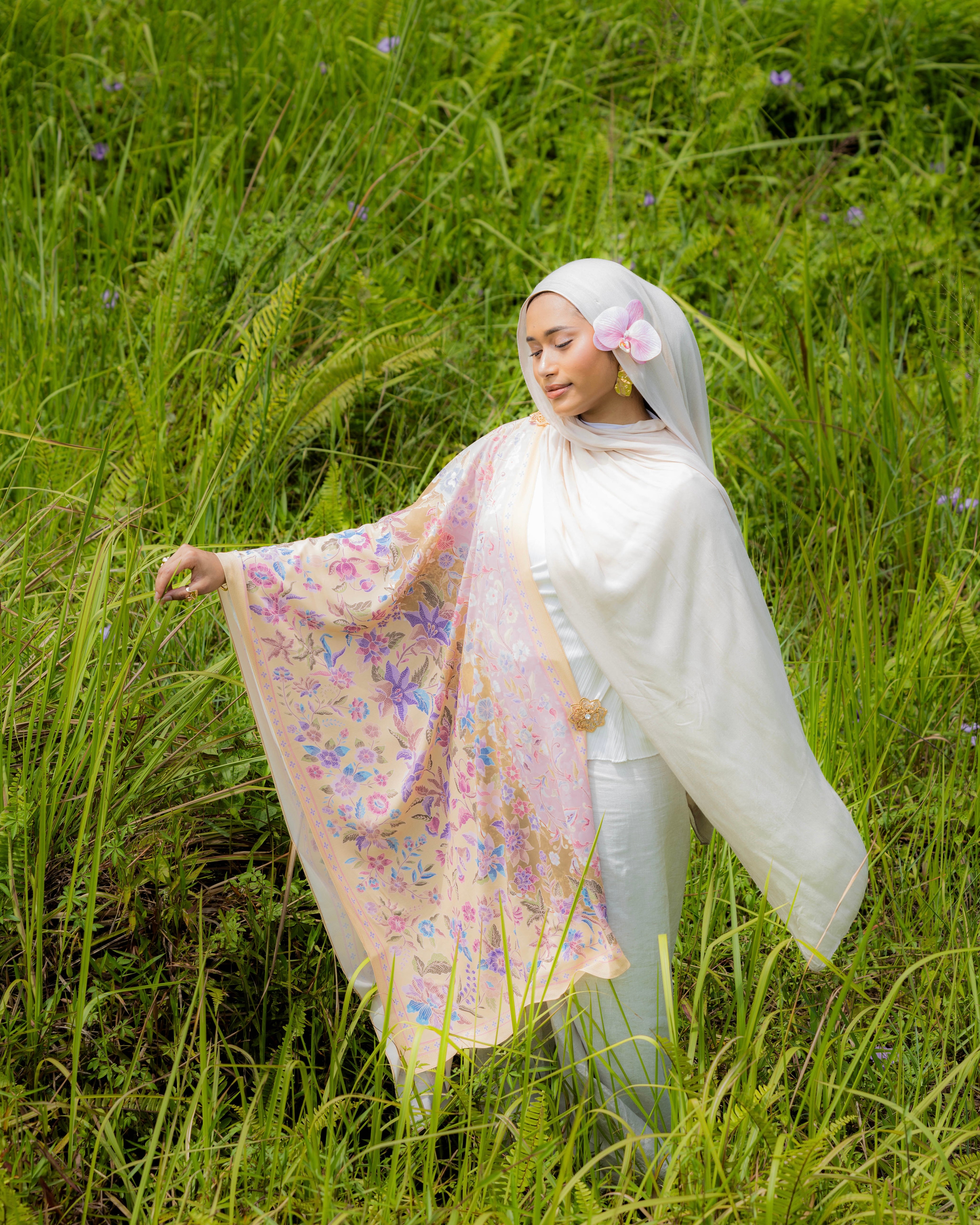 Woman wearing a Soof Sarung in Nabilah floral chiffon, light brown and pink headscarf.