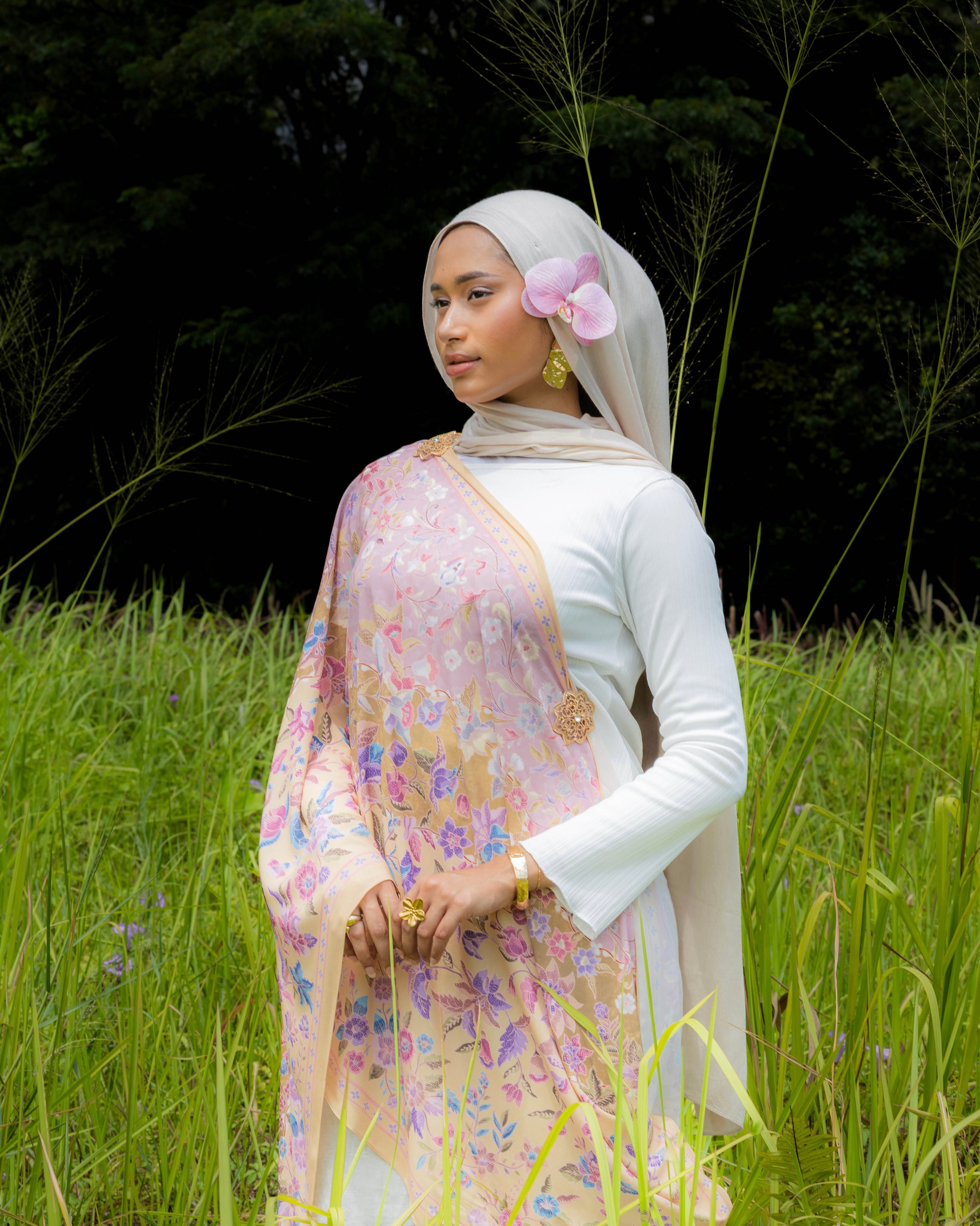 Woman wearing a Soof Sarung in Nabilah floral chiffon, Light brown and pink headscarf. 