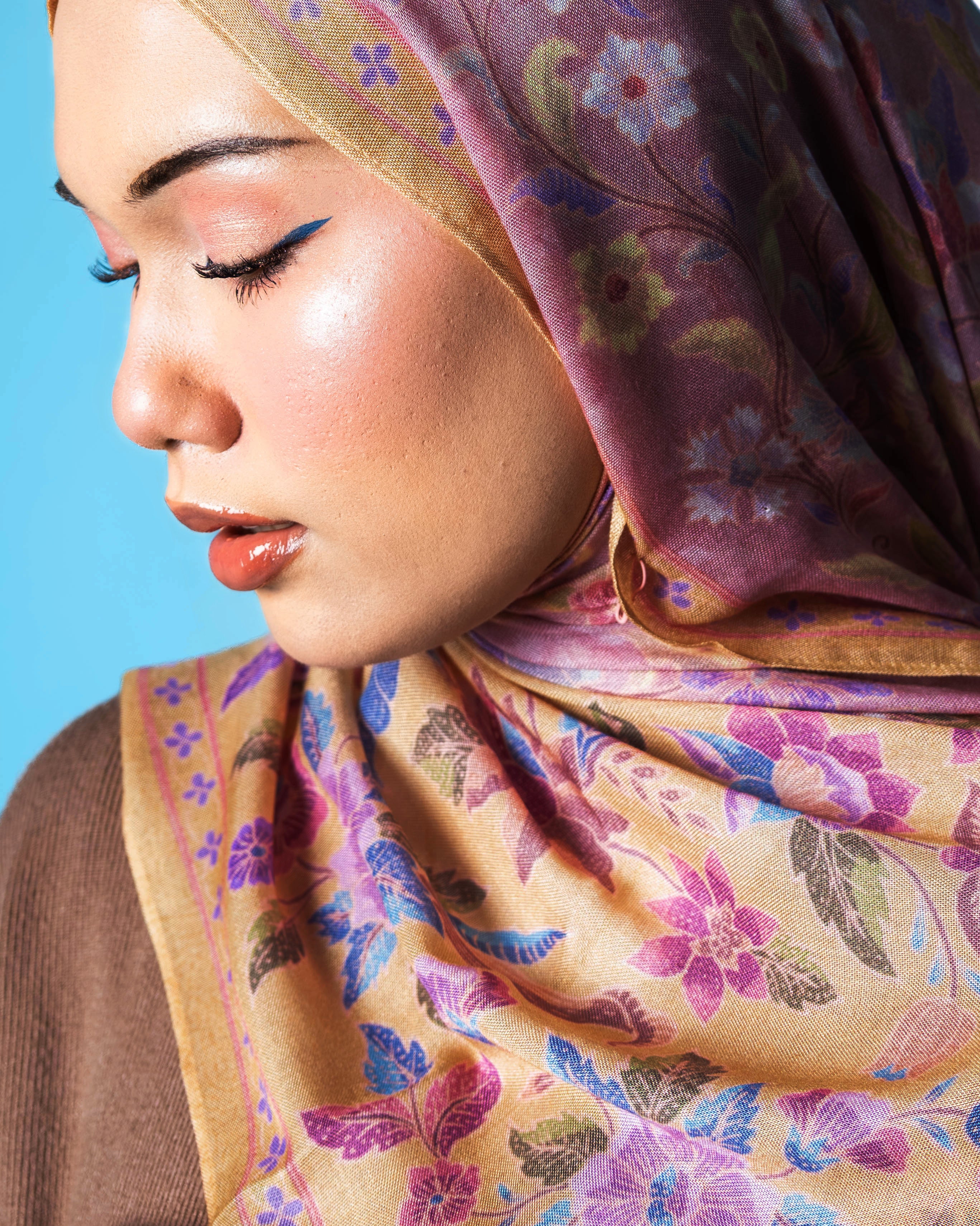 Woman wearing a Soof Sarung in Nabilah floral modal shawl, pink and yellow headscarf. 